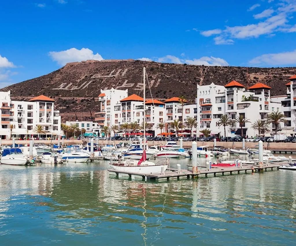 Agadir marina, white seafront buildings and the kasbah hill